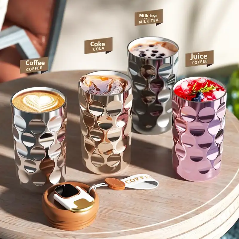 Silver metallic cup with circular cutouts, modern design.