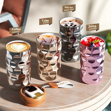 Silver metallic cup with circular cutouts, modern design.